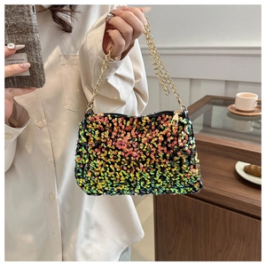 Close-up of vibrant multi-color sequins and golden chain strap on a stylish handbag
