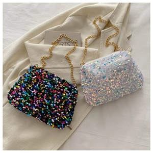 Detailed shot of two colorful sequin crossbody bags with gold metal chain straps