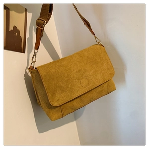 Detail view of ginger yellow corduroy crossbody bag with adjustable wide fabric strap