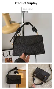 Detail of glitter fabric handbag with knotted handle and elegant gold metal ring hardware