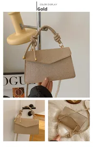 Detail of gold woven handbag featuring a knotted rope handle and shimmering fabric texture