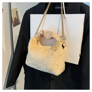 Detail of plush off-white handbag featuring soft faux fur and pleated leather handle