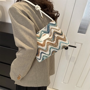 Bohemian striped knit bucket bag with a stylish wave pattern and refined knot strap