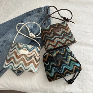 Three knit bucket bags in beige, brown and black with wave patterns and leather logo