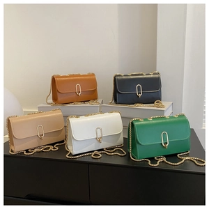 Detail of five-color textured leather crossbody bags with gold oval buckles and chain straps