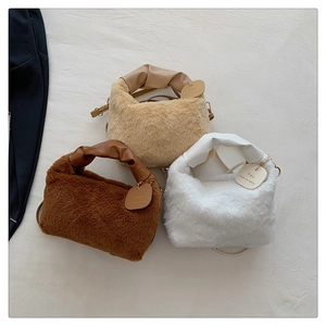 Detailed texture of plush faux fur handbags in beige, brown, and white with leather handles