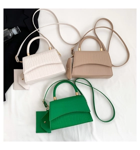 Detailed top view of crocodile pattern crossbody bags with woven handles and coin purses