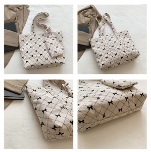 Detail view of corduroy tote bag set with black bow patterns and quilted texture