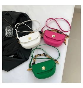Three semi-circular saddle bags in white, pink, and green with silk scarf metal handles