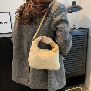 Chic cream plush shoulder bag with heart charm and ruffled handle for city commuting