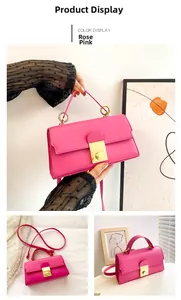 Rose pink handbag with golden circular lock and thin shoulder strap shown in detail