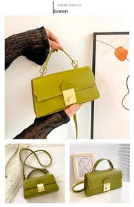 Detail of green PU leather handbag with gold ring hardware and square turn-lock closure