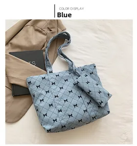Blue corduroy tote bag set with black bow patterns and matching small pouch