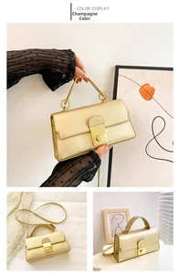Detail view of champagne handbag showing square turn-lock closure and ring handle
