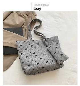 Grey corduroy tote bag set with black bow prints and a matching quilted mini pouch
