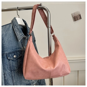 Pink faux leather hobo bag featuring silver adjustable buckle and natural grain texture
