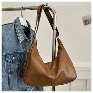 Detail view of brown vintage PU leather hobo bag with smooth oil-wax texture and wide strap