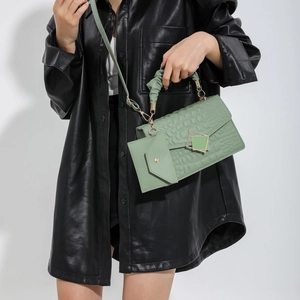 Green faux-crocodile textured handbag set with metal buckle and matching pouch
