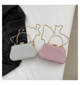 Detailed view of sequined evening clutch bags with metallic handles and chain straps