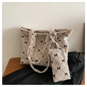 Detail of beige corduroy tote bag with diamond pattern and matching small pouch