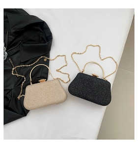 Detail of glitter evening clutch bags in gold and black with floral metal clasps