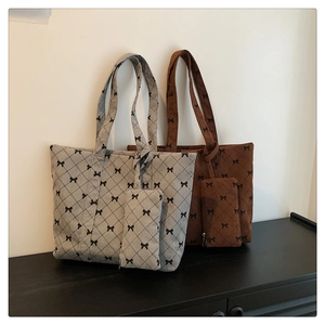 Detail of corduroy tote bag featuring rhombus pattern and sweet black bow prints