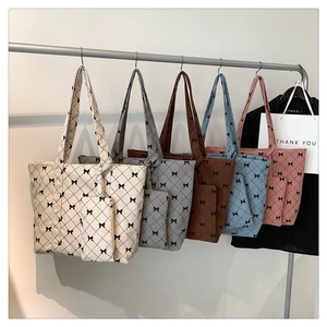 Detailed corduroy tote bags with bow patterns and matching small pouches in five colors