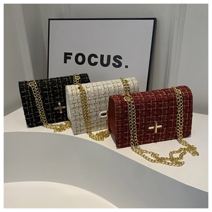 Three elegant tweed crossbody bags with gold chains and metallic twist locks in a row