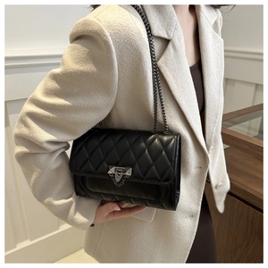 Classic black quilted leather crossbody bag with metal chain strap and turn-lock closure