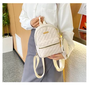 Detail of cream quilted oxford backpack with golden logo and matching round coin purse