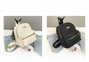 Quilted oxford fabric mini backpacks in black and white colors with gold metal zippers
