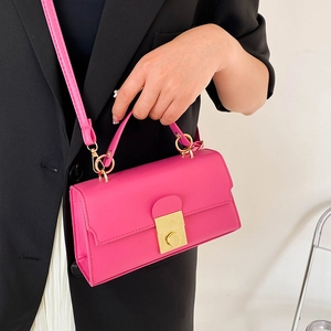 Fashionable bright pink leather handbag with gold square lock and detachable shoulder strap