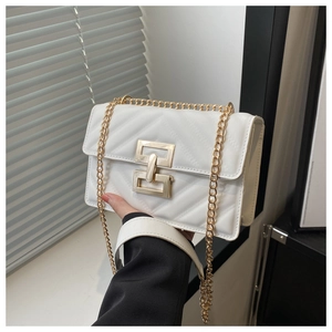 Detailed close-up of white quilted leather texture with gold geometric twist-lock buckle