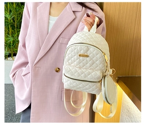 White quilted nylon backpack with a detachable coin purse and gold metal hardware