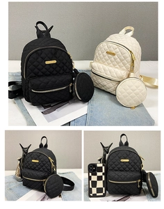 Detail of quilted oxford backpacks in black and beige with mini round pouches