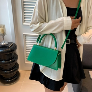 Chic lime green leather crossbody bag with gold hardware and top handle for women