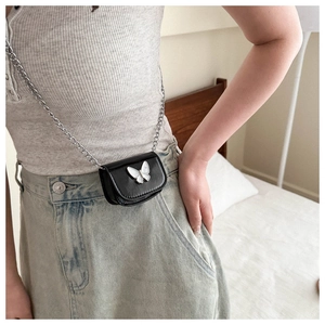 Mini black leather crossbody bag with silver butterfly charm and chain strap