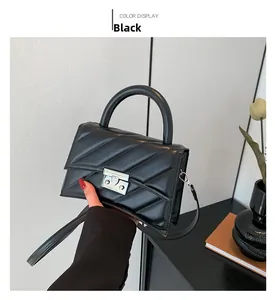 Détail d'un sac à main en cuir PU noir avec motif matelassé en V et boucle métallique