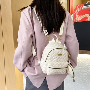 Minimalist white quilted nylon backpack for women featuring a matching mini round coin purse