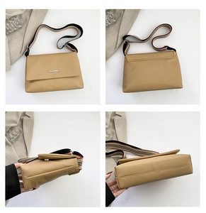 Detail view showing khaki lychee grain PU leather texture and striped wide shoulder strap