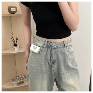 Macro view of silver mirror leather mini bag with 3D metal butterfly and chain