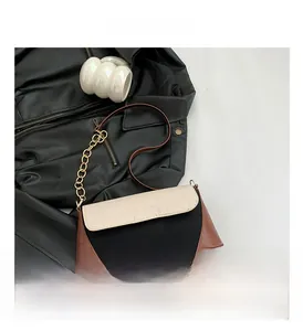 Close-up of tricolor crocodile pattern shoulder bag with gold chain and push-lock