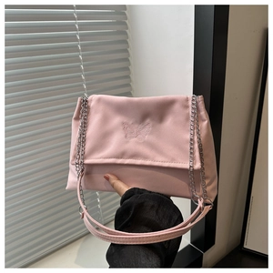 Close-up of pink shoulder bag featuring butterfly embroidery and silver metal chain strap
