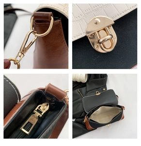 Detail view of contrast stitching, gold hardware, and crocodile pattern on baguette bag