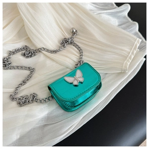 Detail view of mini metallic green saddle bag with silver butterfly clasp and chain