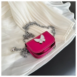 Detailed view of rose red mini saddle bag with silver chain and white butterfly clasp