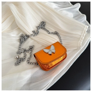 Detail of mini orange metallic crossbody bag with silver butterfly and chain strap