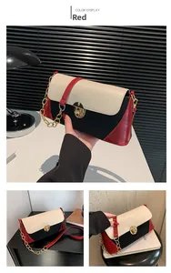 Close-up of tricolor leather baguette bag with gold buckle and crocodile texture