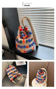 Close-up of khaki plush bucket bag showing colorful 3D tufted polka dot textures