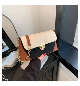 Detail of tricolor leather bag with gold chain strap and crocodile texture flap